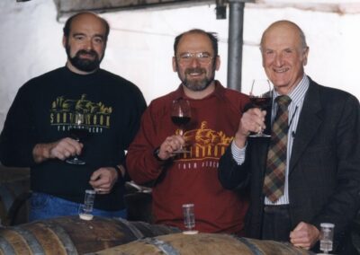 Derek Barnett, Bill and Ernest Redelmeier holding wine glasses