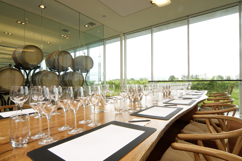 Picture of the tasting room. Oak table with wine glasses